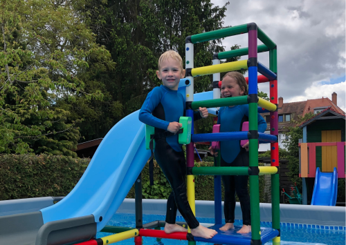 Two children on a water slide